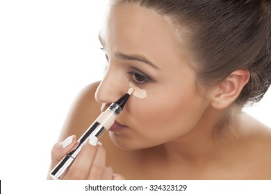 Young Woman Apply Concealer Under The Eye