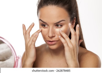 Young Woman Apply Different Shades Of Liquid Foundation On Her Face