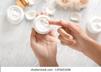 Young Woman Applying Body Cream, Closeup