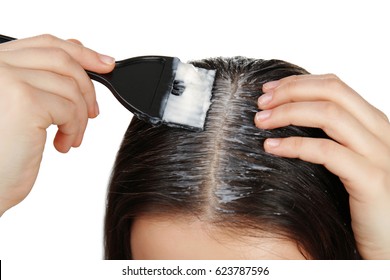 Young Woman Applying Coconut Oil Onto Hair, Closeup