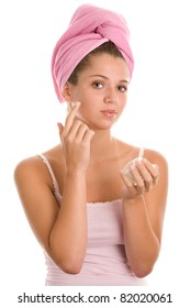 Young Woman Applying Cream On Face