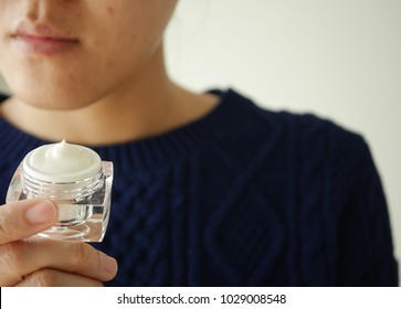 young woman applying cream,moisturizer, cosmetic,skin care regimen.skincare step for acne prone skin medication.