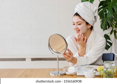 Young Woman Applying Face Mask At Home. Natural Skin Care Routine For Glowing Skin.