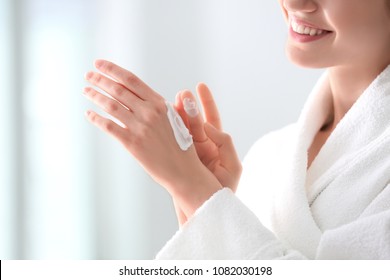 Young Woman Applying Hand Cream At Home, Closeup