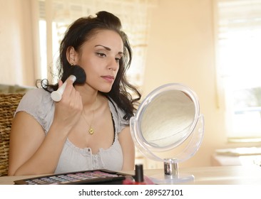 Young Woman Applying Makeup With Brush