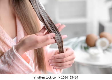 Young Woman Applying Mask Onto Hair At Home