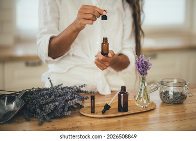 Young woman applying natural organic essential oil on hair and skin. Home spa and beauty rituals. Skin care. - Powered by Shutterstock