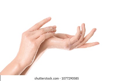 Young woman applying natural scrub on hands against white background