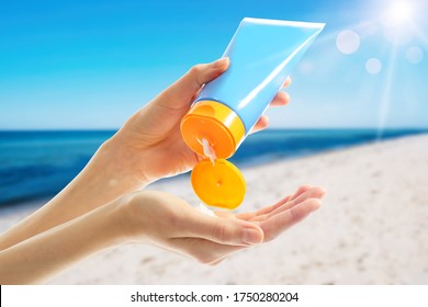 Young Woman Applying Sun Protection Cream Near Sea, Closeup