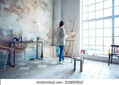 Young woman artist painting at home creative standing drawing - Powered by Shutterstock