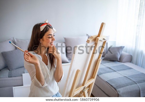 Young woman artist painting\
at home creative abstract picture. Young Woman As Artist Painting\
At Home For Art Creativity. Woman enjoying her hobby of painting at\
home