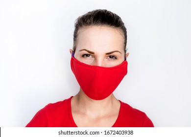 A Young Woman In Asian, Wearing A Red Medical Mask. A Girl With A Serious And Angry Face Is Looking Directly At The Camera. Smog Protection