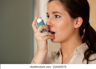 Young Woman With Asthma Inhaler.