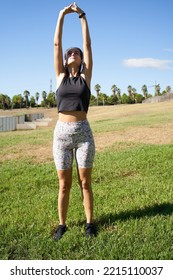 Young Woman Athlete Stretching His Arms In The Air Before Exercising. Muscle Stretching Before Exercise