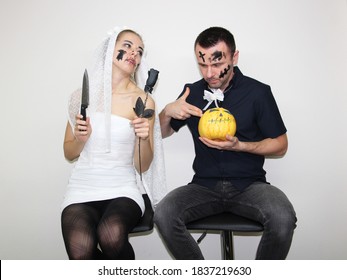 Young Woman And Attractive Man Wearing Halloween Costumes For Party. Celebrating Halloween In 2020 At Home Quarantine. Situation Caused By Coronavirus. Bride And Fiance Prepared For Dark Wedding.