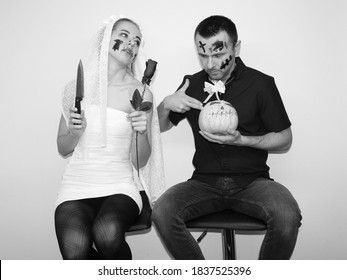 Young Woman And Attractive Man Wearing Halloween Costumes For Party. Celebrating Halloween In 2020 At Home Quarantine. Situation Caused By Coronavirus. Bride And Fiance. Dark Wedding.