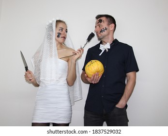 Young Woman And Attractive Man Wearing Halloween Costumes For Party. Celebrating Halloween In 2020 At Home Quarantine. Situation Caused By Coronavirus. Dark Wedding. 