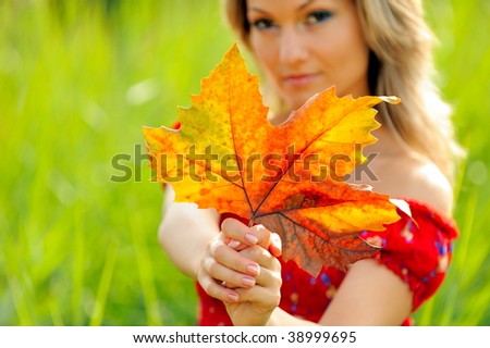 young woman with autumn leaves