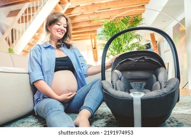 Young Woman With A Baby Car Seat Sitting On The Floor At Home