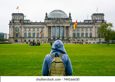 Young Woman With Backpack Looking At Bundestag Building In Berlin. Erasmus Student, Studying Abroad And Tourist Concept.