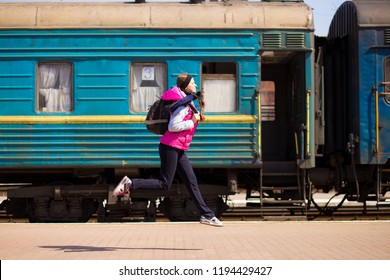 Young Woman With Backpack Run At Railway Station. Travel By Train