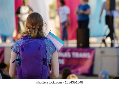 Young Woman With Backpack And Trans Support Flag At A Rally