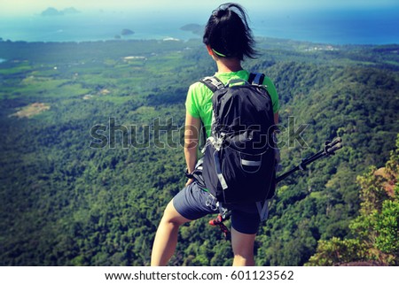 young woman backpacker enjoy the view on mountain peak