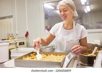 Young Woman Baker In Training Mixes Dough In Baking Pan While Baking Apple Pie