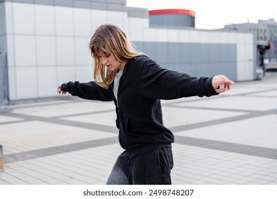 Young Woman Balancing on a Platform in an Urban Environment During Early Morning - Powered by Shutterstock