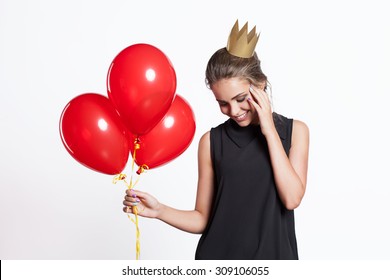 Young woman with balloons and a princess crown on his head
