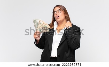 young woman with banknotes feeling stressed, anxious, tired and frustrated, pulling shirt neck, looking frustrated with problem Foto stock © 