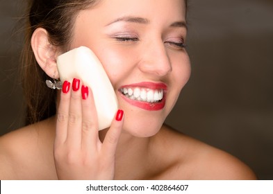 Young Woman Bare Skin Shoulders Using Bar Of Soap Applying To Cheek.