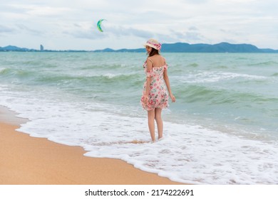 Young Woman Barefoot Walking On The Sand Beach.