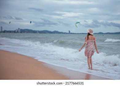 Young Woman Barefoot Walking On The Sand Beach.
