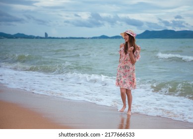 Young Woman Barefoot Walking On The Sand Beach.
