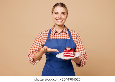 Young woman barista bartender barman employee wear blue apron red shirt work in coffee shop hold point on cake dessert order isolated on plain pastel beige background. Small business startup concept - Powered by Shutterstock