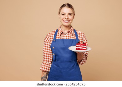 Young woman barista bartender barman employee wear blue apron red shirt work in coffee shop hold plate with cake dessert order isolated on plain pastel beige background. Small business startup concept - Powered by Shutterstock