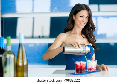 Young Woman Bartender Pouring Cocktails