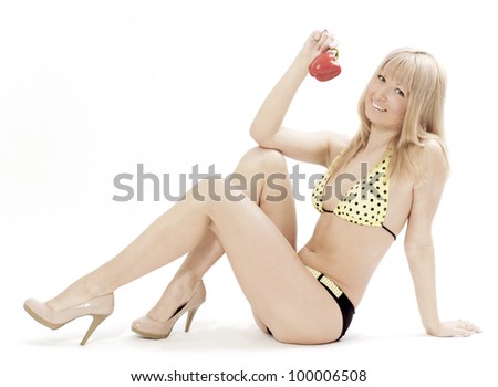 	The young woman in a bathing suit with red pepper