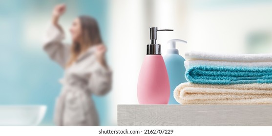 Young woman in the bathroom at home and accessories in the foreground