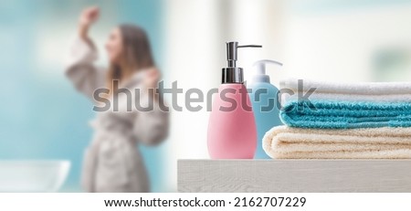 Young woman in the bathroom at home and accessories in the foreground