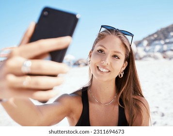 Young woman, beach selfie and smile with beauty, outdoor and summer vacation in sunshine for blog. Girl, happy influencer and photography for travel, social media and sea holiday in Rio de Janeiro - Powered by Shutterstock