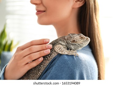 Young Woman With Bearded Lizard At Home, Closeup. Exotic Pet