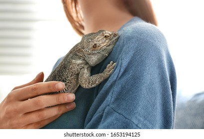 Young Woman With Bearded Lizard At Home, Closeup. Exotic Pet