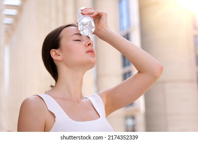 Young Woman, Beautiful Girl Is Suffering From Summer Heat Stroke, Hot Weather, Sweaty And Thirsty, Refreshing With Hand In Blowing, Holding Cold Water Plastic Bottle Of Water, High Temperature 