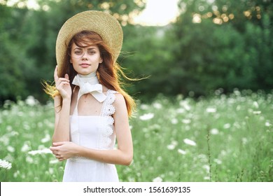 young woman in a beautiful hat in the fresh air