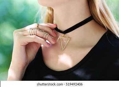 Young woman with beautiful rings and choker