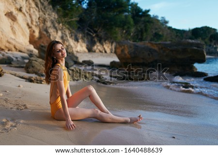 young woman with a beautiful slim figure in a swimsuit on vacation