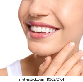 Young woman with beautiful smile on white background, closeup. Teeth whitening