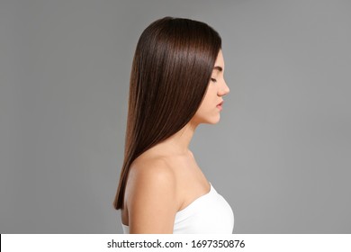 Young woman with beautiful straight hair on grey background - Shutterstock ID 1697350876